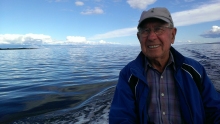 Frank Jelich at the helm, mountains in the background, another beautiful day for fishing